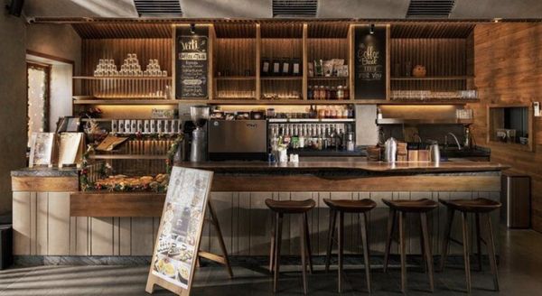 ban-ghe-quay-bar-cho-quan-tra-sua-2-tu-trung-hieu-an-moc_67a65579f931412bb81170fbde92e0bf_grande Ghế gỗ bar cao mang màu nâu trầm hợp với các quán phong cách vintage